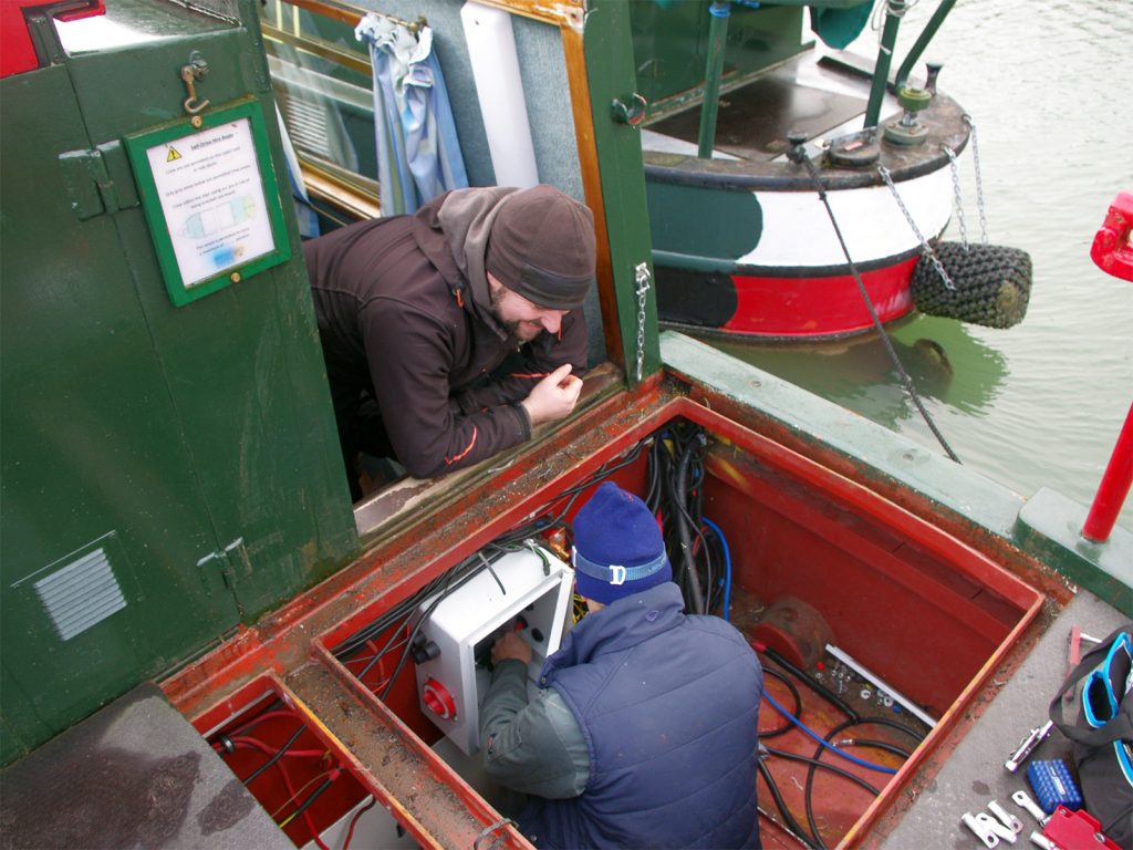 Volunteers maintaining the boat