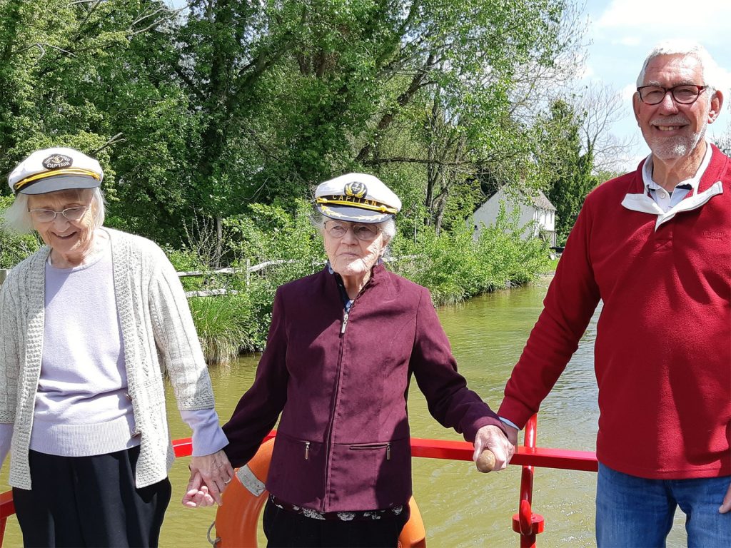 Elderly lady driving the boat